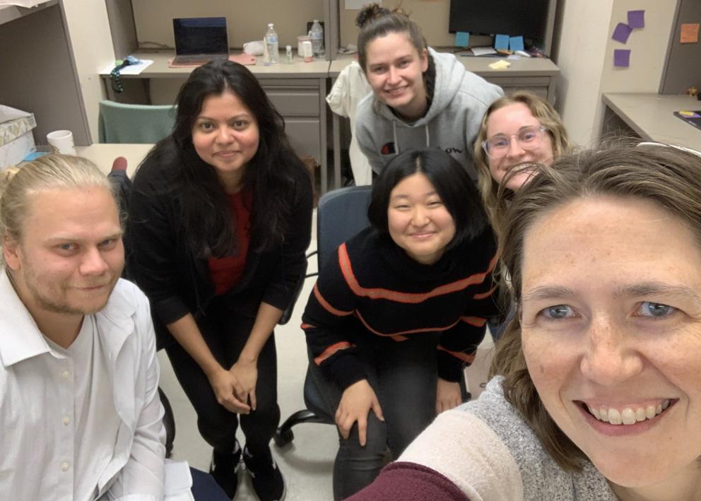 Selfie of 6 people smiling in office space