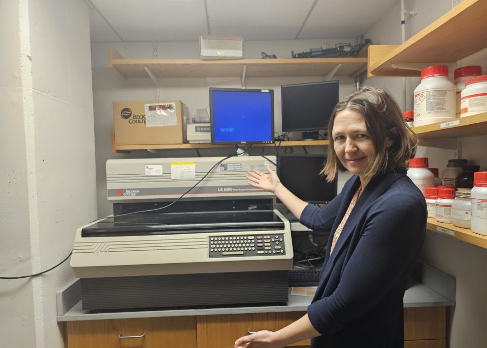 Woman poses with scintillation counter