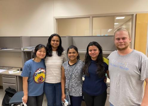 Lab team members smiling for a picture with no masks on