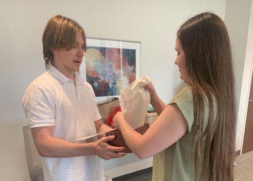 A man gives a woman a gift