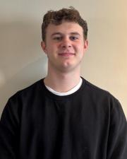 Man in black sweater smiling 